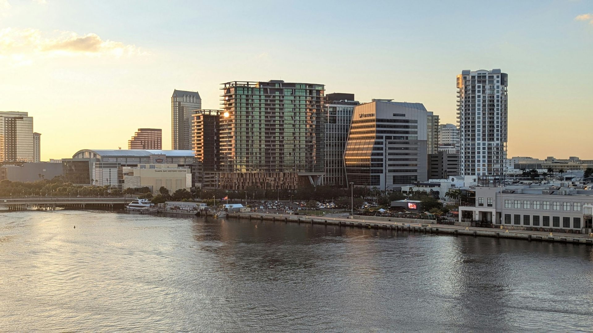 Downtown Tampa Bay skyline at sunset overlooking the water near USF and Riverwalk.