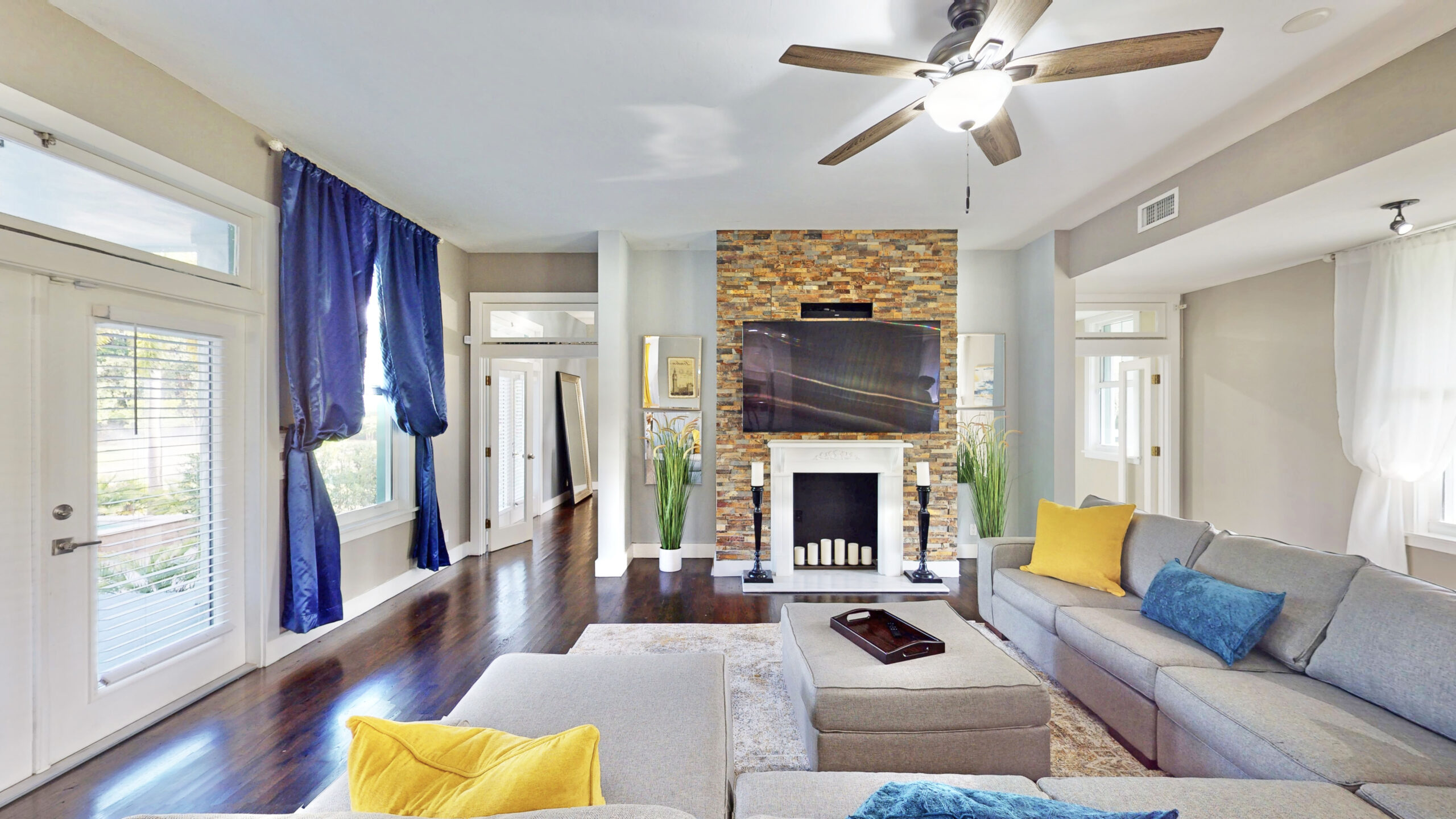 Luxury living room with stone fireplace and modern décor at Saint Patrick Palace in Davie, FL.